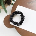 Elegant black satin scrunchie with high elasticity shown on a minimalist wooden background - Small / Black