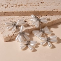Detail of elegant teardrop faux pearl tassel earrings on a natural stone background - Triple Layer Pearl Tassel Style / Silver