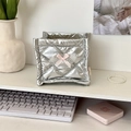 Detail of silver quilted storage box with white lace wings and pink ribbon bow on a desk - Diamond Grid Silver
