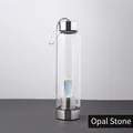 Crystal energy glass water bottle featuring a central natural opal pillar with silver base - Opal Bottle