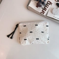 Close-up of small floral fabric pouch with black bow print and zipper handle detail - Black Polka Dot Small Bow