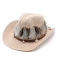 Detail of woven straw cowboy hat featuring natural feathers and silver metal accents - Pink