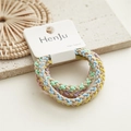 Detailed view of candy-colored twisted hair ties on card with high elastic woven texture - Rainbow Multi-color