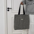 Detail of herringbone woven tote bag with black strap and ATYRG brand logo patch - Woolen Stripe Black