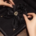 Elegant black pearlescent fabric hair scrunchie with a gold rhinestone centerpiece ornament - Pearlescent Black