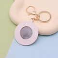 Pink heart-shaped PU leather keychain mirror with gold lobster clasp on a beige tray - Round White
