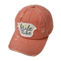 Detailed macro view of embroidered bride tribe patch and distressed cotton baseball cap - Orange