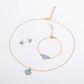 Detail of gold heart jewelry set including blue enamel necklace, bracelet and earrings - Blue