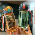 Minimalist portable plastic water cups in amber and green with colorful caps - Orange + Green