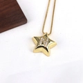 Close-up of gold star pendant with letter N and micro-inlaid zircon on a box chain - Letter N