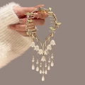 Golden hair claw clip with green enamel leaves, rhinestones, and white lily tassels - F0440 Gold Forest Leaf