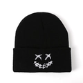 Black knit beanie featuring white embroidered skull smile for street style and warmth - One Size / Black