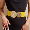 Detail of yellow elastic waist belt with textured gold circular buckles on black dress - Yellow