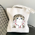 White canvas tote bag featuring a cute cartoon cat illustration with pink paw pads - Cat with Fists