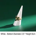 White conical ring display stand 2.5x6cm with gold butterfly ring on green background - White