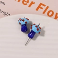 Macro shot of handmade light blue glass mushroom beads with red dots for jewelry making - No.21 (Blue Cap Red Dot Earring Style)
