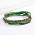Close-up of red and green beaded elastic body chain with fine glass bead texture - Red and Green Stripe