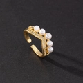 Detailed macro view of gold crown ring featuring white pearls and micro-pave cubic zirconia - Crown Pearl Micro-inlay Style