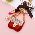 Golden keychain with red enamel bag, pink lipstick charm, pearl and black silk bow - Red Enamel Handbag