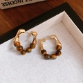 Close-up of golden C-shaped hoop earrings with brown tiger eye beads on white linen - 5# C-Shape Five Bead Tiger Eye (5#)