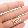 Close-up of gold 1991 birth year pendant with gothic font on a fine link chain - 1991 / Gold