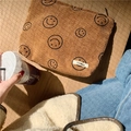 Detailed texture of brown corduroy makeup bag with cute smiley face and zip closure - Brown Smile