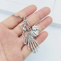 Silver gothic Halloween keychain featuring skeleton, heart, and hand bone charms - Gothic Skull Heart Bone (Gothic)