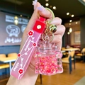 Pink castle liquid quicksand keychain with stars, golden bell and Happy Moments strap - Red Luminous Bubble Bead Castle