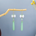 Detail of long drop earrings featuring a white bow and green teardrop pendant on wood - Fresh Bowknot Gradient Waterdrop Earrings(E4168-1)