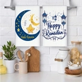 Two-piece Happy Ramadan white cotton kitchen towels hanging on white brick wall background - Ramadan Lantern and Crescent Greeting Style (MJBT66-54) / 2 Pieces/Pack (40*60cm) / Ramadan White