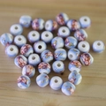Detailed macro view of hand-painted blue and white ceramic beads with pink floral patterns - No.45-Pink Blue Floral