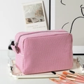 Pink striped seersucker makeup bag with silver zipper and side handle for travel storage - Pink White