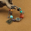 Detail of Tibetan-style bracelet with carved metal plate, turquoise beads, and eye motif - Buddha Eye Female Fortune God Cotton Rope Woven Bracelet