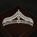Elegant silver bridal crown with pearls and rhinestones on a premium dark wood background - Style HG-061