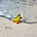 Detail view of a yellow duck alloy charm with 2g weight and 7x17mm dimensions - Yellow Duckling 8-44