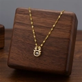 Elegant gold reindeer pendant necklace with a shimmering white dancing cubic zirconia stone - Gold