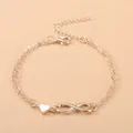 Golden double layer chain bracelet featuring a smooth heart and infinity symbol charms - Gold