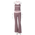 Detailed view of polka dot halter crop top and matching flared pants on a ghost mannequin - S / Pink