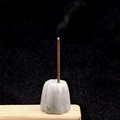 Carved natural crystal flower incense holder with burning stick on black background - Labradorite