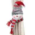 Christmas snowman curtain tieback featuring a striped knit hat on a beige linen curtain - Snowman Style