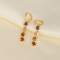 Elegant gold drop earrings with four colorful square zircons on premium silk background - Gold