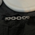 Macro detail of silver geometric links with pavé crystals on black paper background - Silver Chain Link Bangle