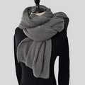Detailed texture of thick dark grey knitted winter scarf with soft fringe edges - Dark Gray