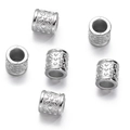 Macro shot of silver hollow cylindrical beads with intricate vintage floral carvings - Silver Style 13 (Hollow Tube)