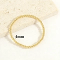 Close-up of 18K gold-plated 4mm metal bead elastic bracelet on stone display base - 4mm