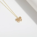 Golden bow necklace with a center pearl, star cutouts and sparkling pavé crystals - Star and Butterfly