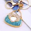 Golden handbag keychain with light blue and white crystals and a center heart-shaped jewel - Blue Heart Handbag Keychain