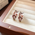 Close-up of wide silver leopard print C-shaped earrings in a wooden jewelry box - Matte Silver Leopard Print C-Shape Earring Clasp (24# Silver)