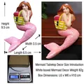 Pink mermaid resin figurine with yellow bag sitting on table edge, 9.5cm height - Mermaid Desk Edge Figurine