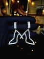 Luxurious silver M-shaped earring with brilliant rhinestones on a dark background - Silver Letter M Shaped Style (DTE1416050S-W)